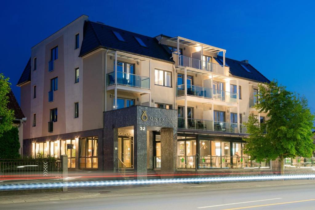 a large building with a sign on the side of it at Onyx Luxury in Sárvár