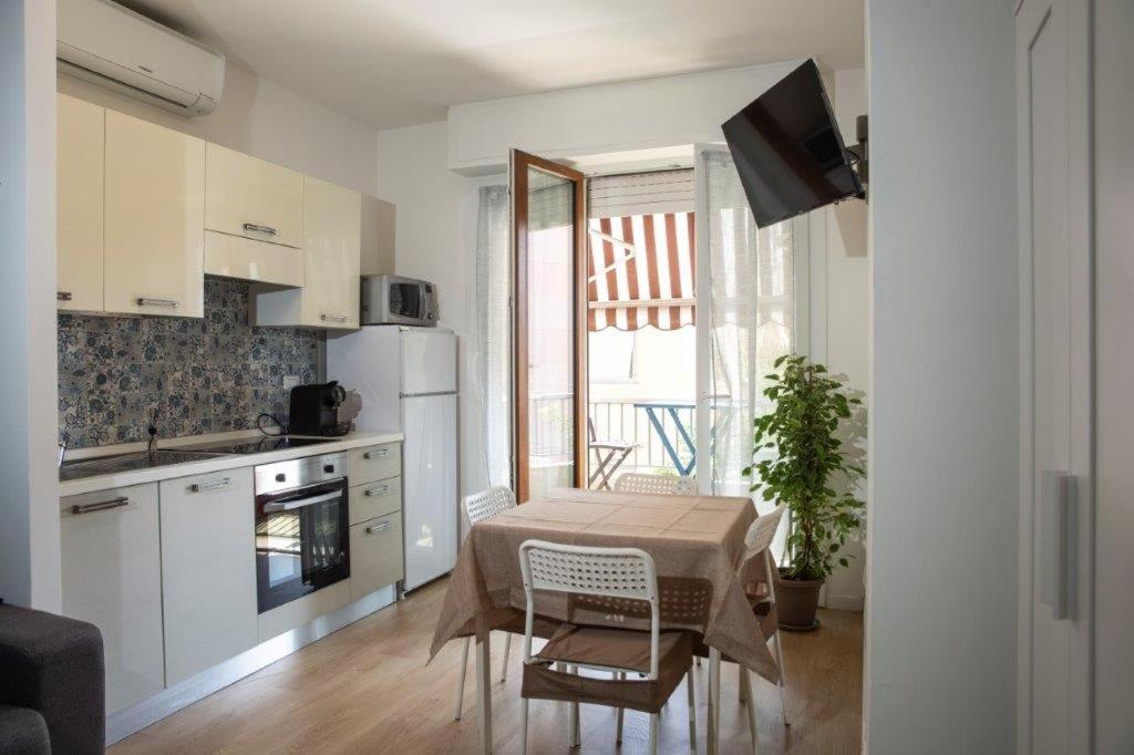 a kitchen with a table and a kitchen with a window at Casa Primavera in Ventimiglia