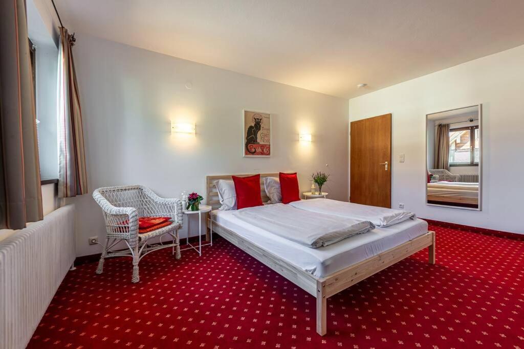 - une chambre avec un grand lit et un tapis rouge dans l'établissement Gipfelblick Residenz #2, à Kitzbühel