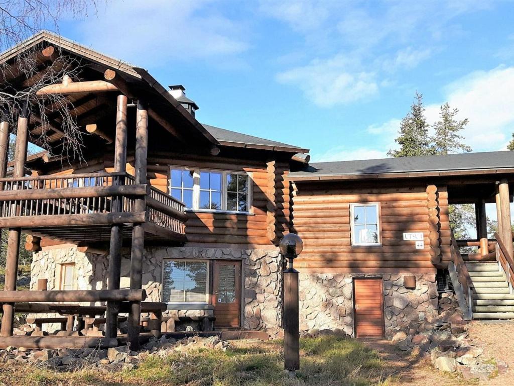a log cabin with a deck and a porch at Holiday Home Utsu 1 by Interhome in Levi