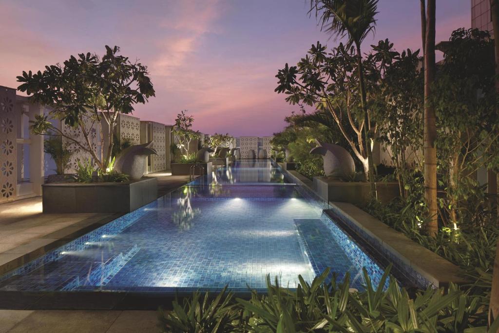 una piscina en medio de un complejo en The Ritz - Carlton, Bangalore, en Bangalore