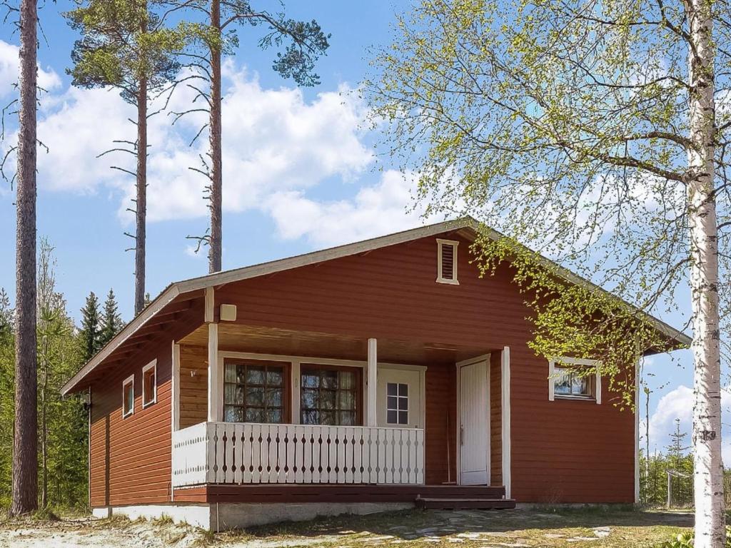 a small house in the middle of some trees at Holiday Home Kuusirinne by Interhome in Savonranta