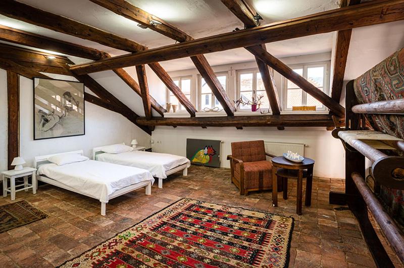a large room with two beds and a couch at Art House Radovljica in Radovljica