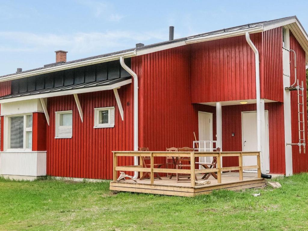 ein rotes Gebäude mit einer Terrasse davor in der Unterkunft Holiday Home Itäkoski 2 by Interhome in Itäkoski