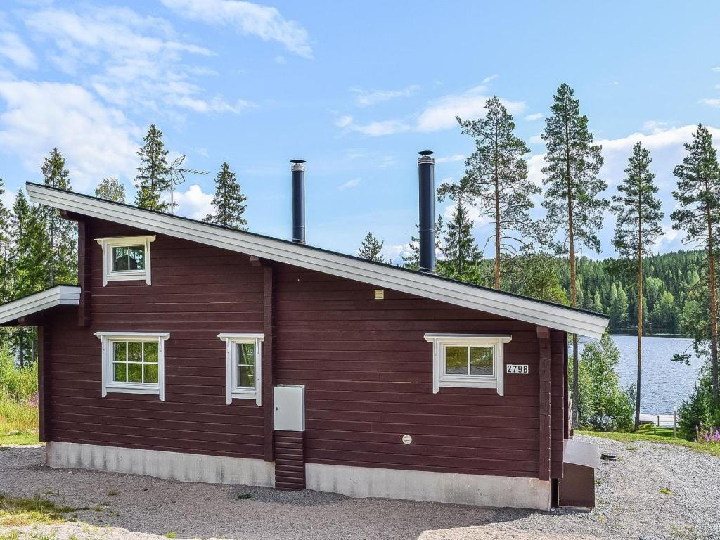 a building with two smoke stacks on top of it at Holiday Home Lekojärven herra by Interhome in Räihä