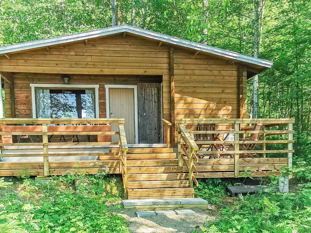 a wooden cabin in the middle of the woods at Holiday Home Pajuranta by Interhome in Oravi