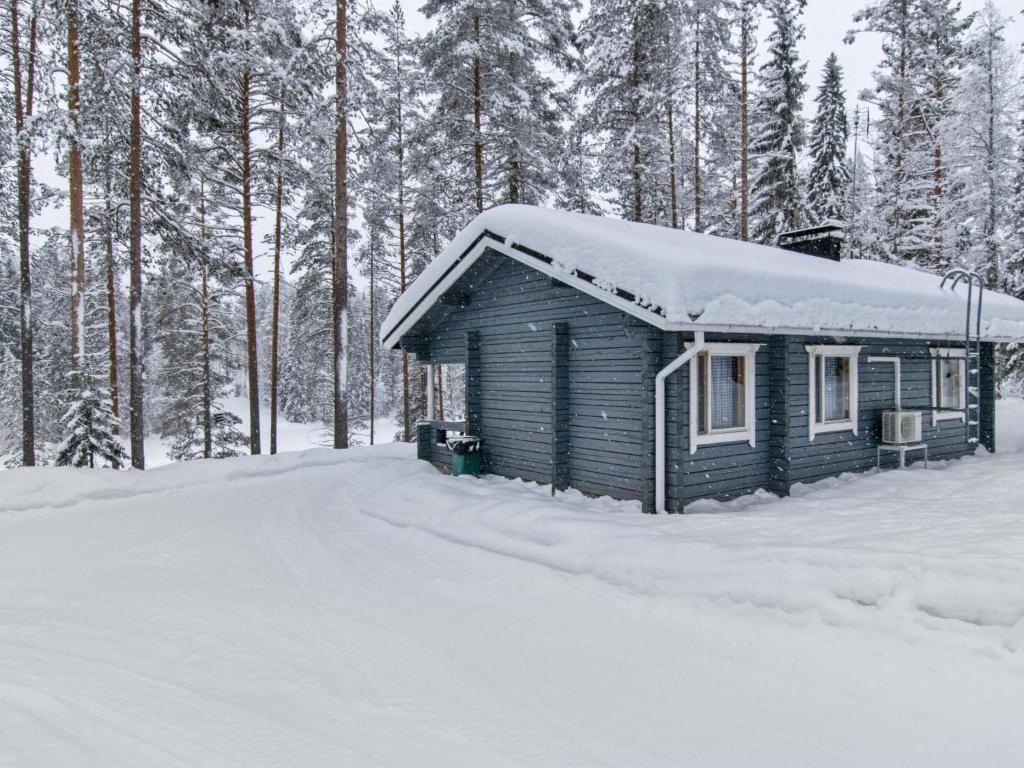 a small cabin in the snow with trees at Holiday Home Lohiukko by Interhome in Kotila