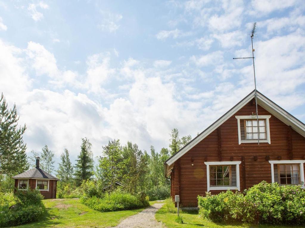 a small wooden house in the middle of a field at Holiday Home Ranta-lemettilä by Interhome in Petäjävesi