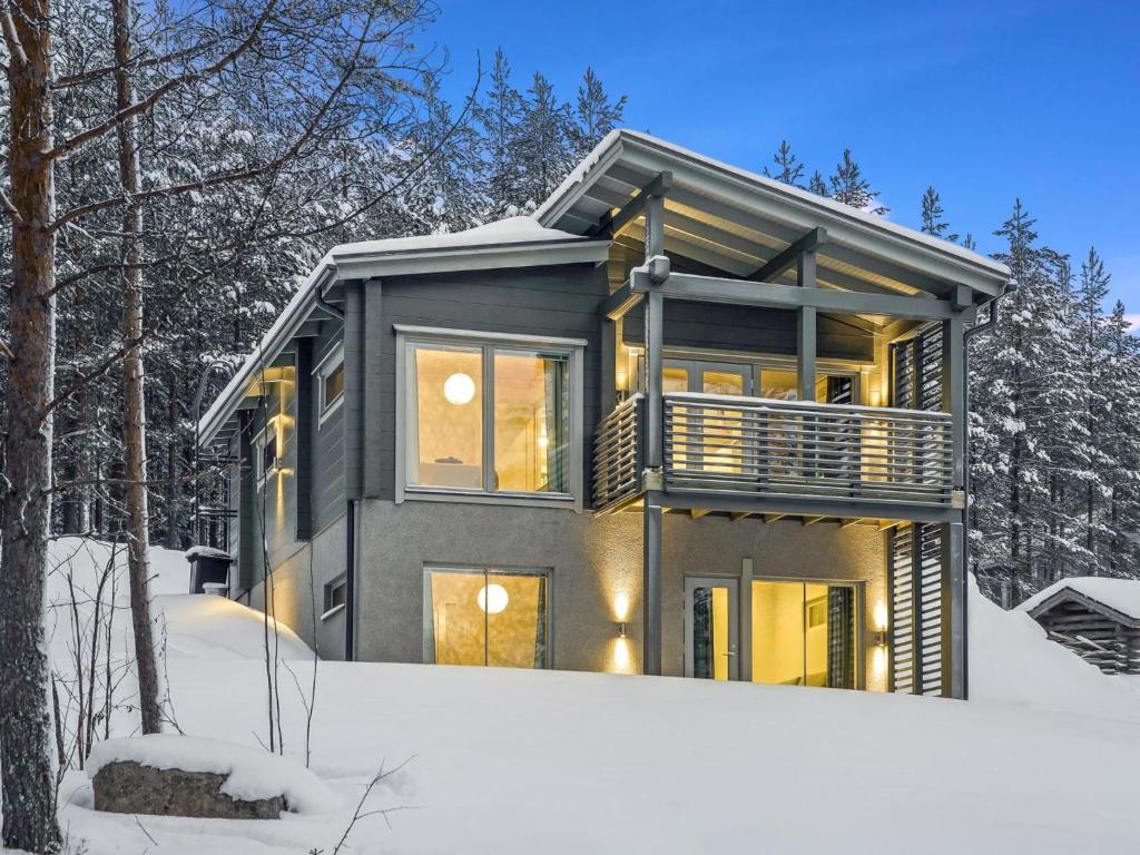 a house in the snow in the woods at Holiday Home Villa ukkohalla by Interhome in Ukkohalla