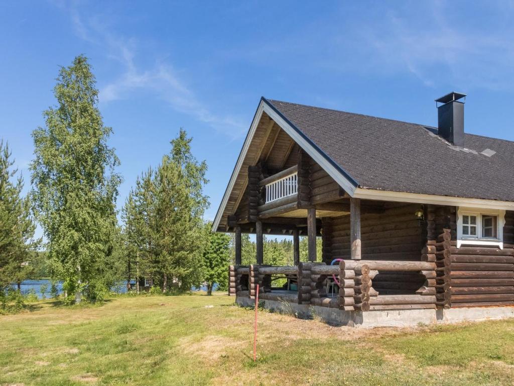 a log cabin with a porch and a roof at Holiday Home Vuokatticottage e by Interhome in Kukkola