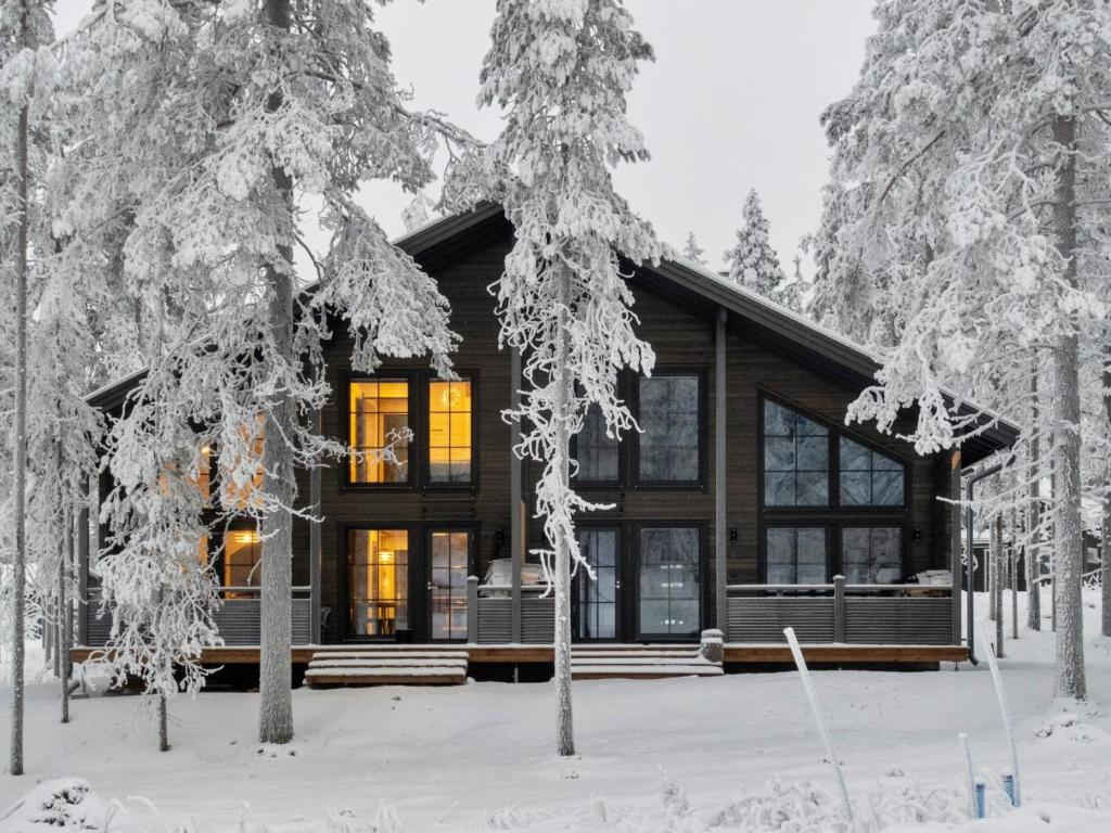 a log cabin in the snow with trees at Holiday Home Westlevi b by Interhome in Sirkka
