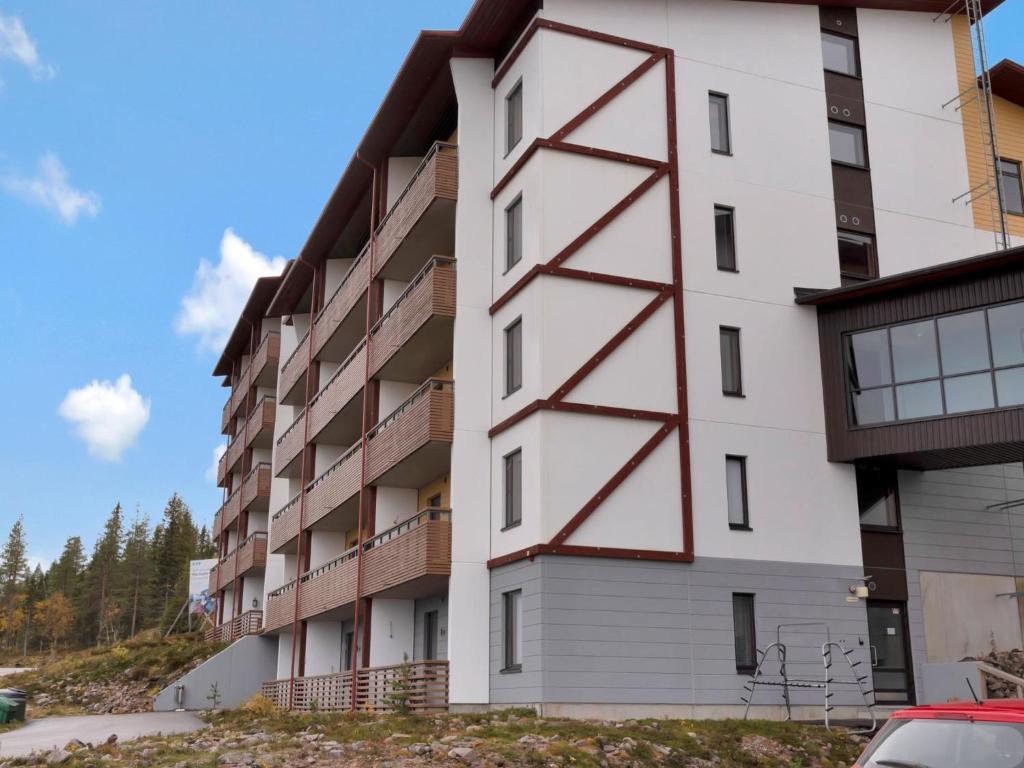 a white building with red detailing on the side at Holiday Home Ylläs chalet 3508 by Interhome in Ylläs