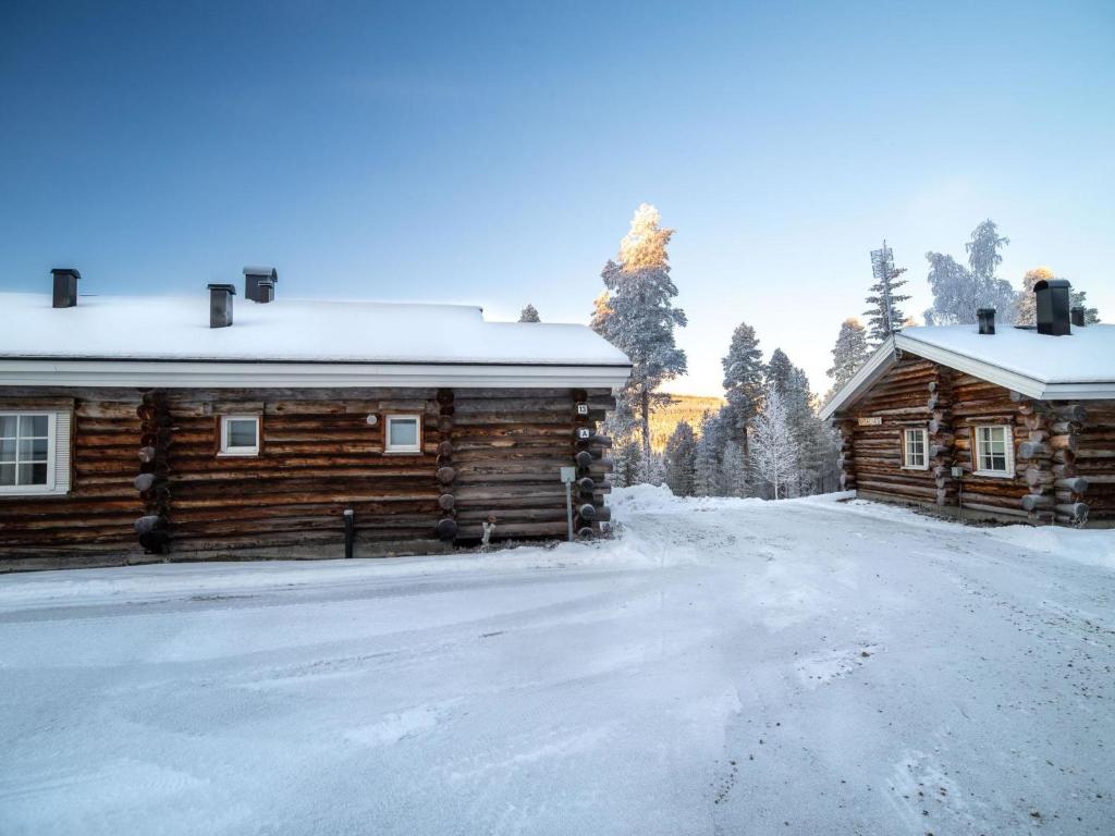 a log cabin in the snow next to a road at Holiday Home Lomaylläs d59 -palovaarankaarre 13 a by Interhome in Ylläsjärvi