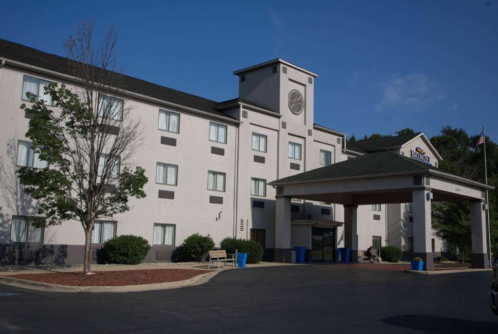 a large white building with a clock tower at Baymont by Wyndham Portage in Portage