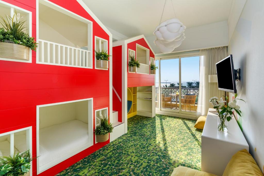 a living room with a red wall at Rixos Bab Al Bahr - Ultra All Inclusive in Ras al Khaimah