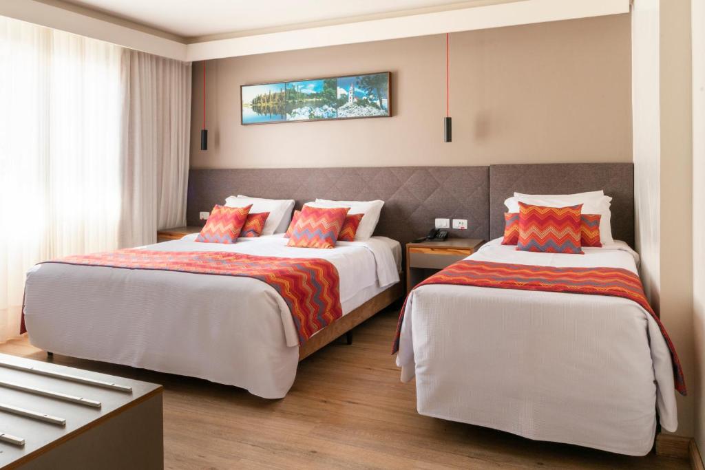 Postel nebo postele na pokoji v ubytování Hotel Laghetto Stilo Centro