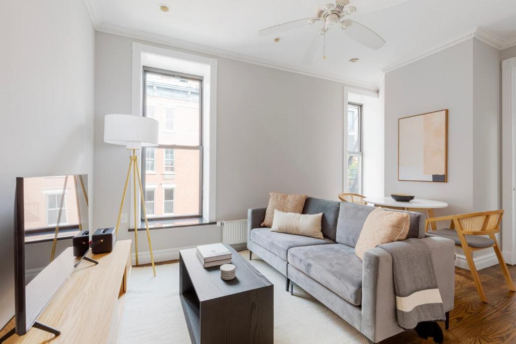 a living room with a couch and a table at East Village 2br w wd nr groceries shops NYC-1235 in New York