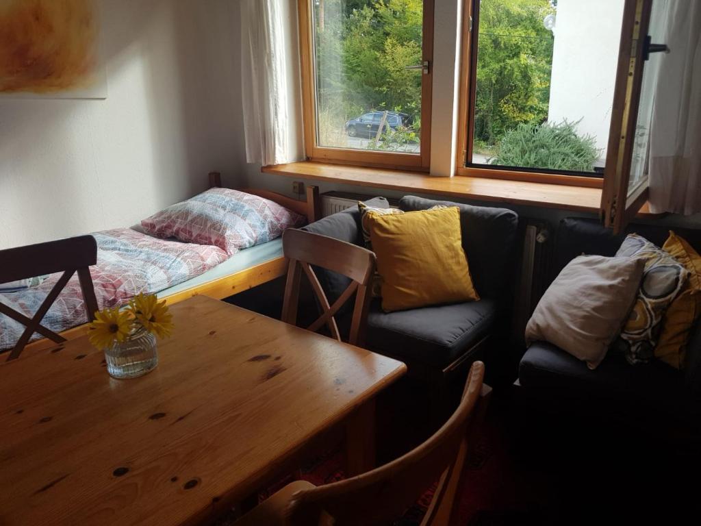 a living room with a couch and a table at Cosy room in the nature in Graz