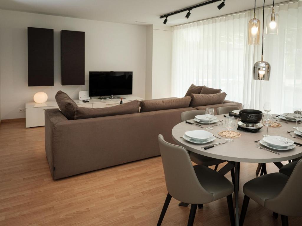 a living room with a couch and a table at Apartment Davinci by Interhome in Täsch