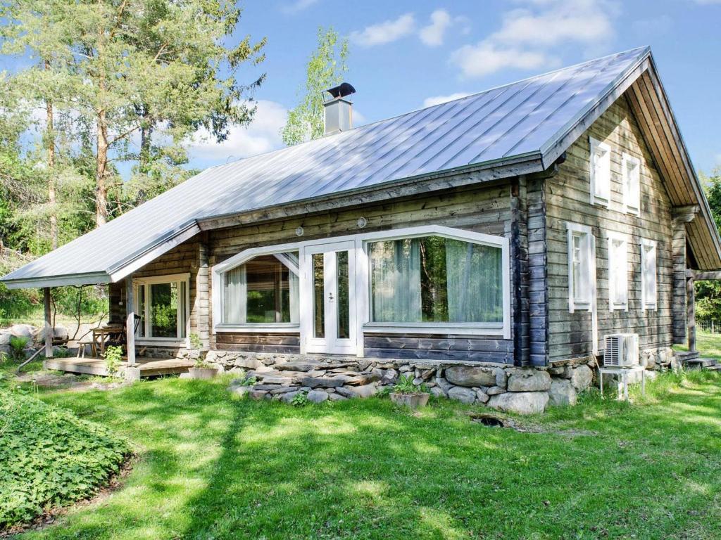 a house with a solar roof on a yard at Holiday Home Ateljee by Interhome in Rääkkylä