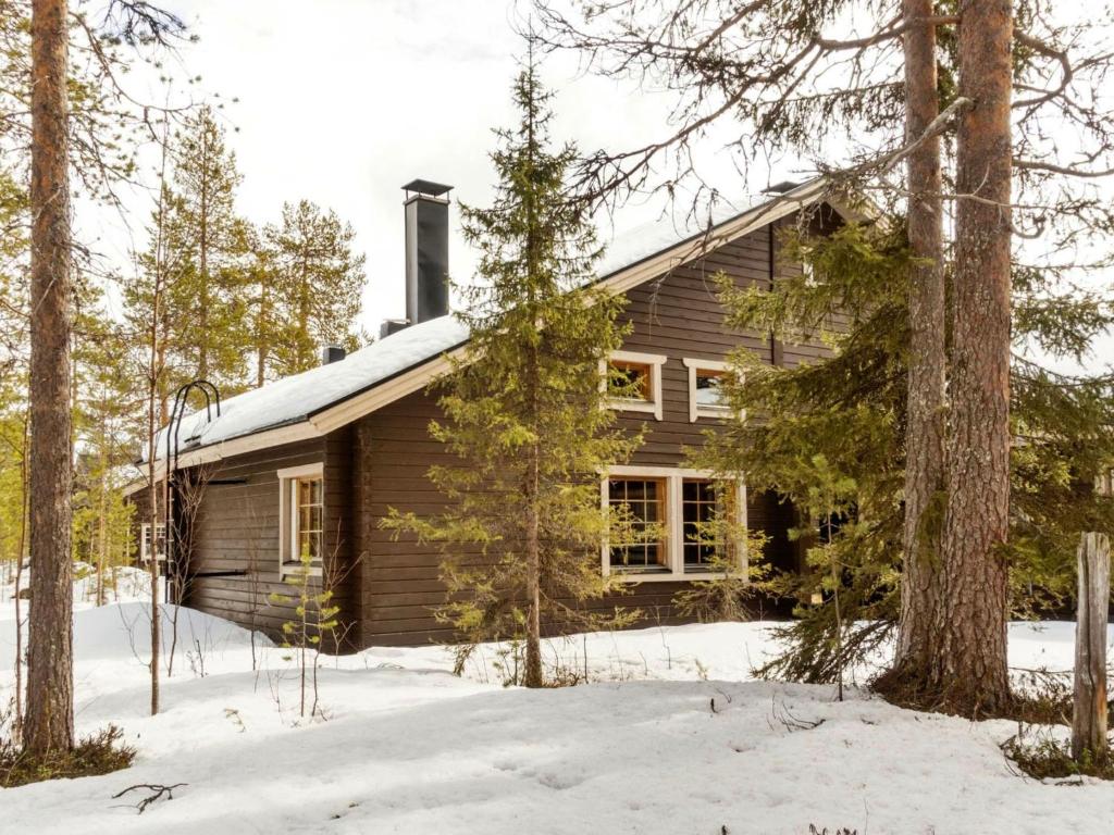 a log cabin in the woods in the snow at Holiday Home Susitupa 5 by Interhome in Salla