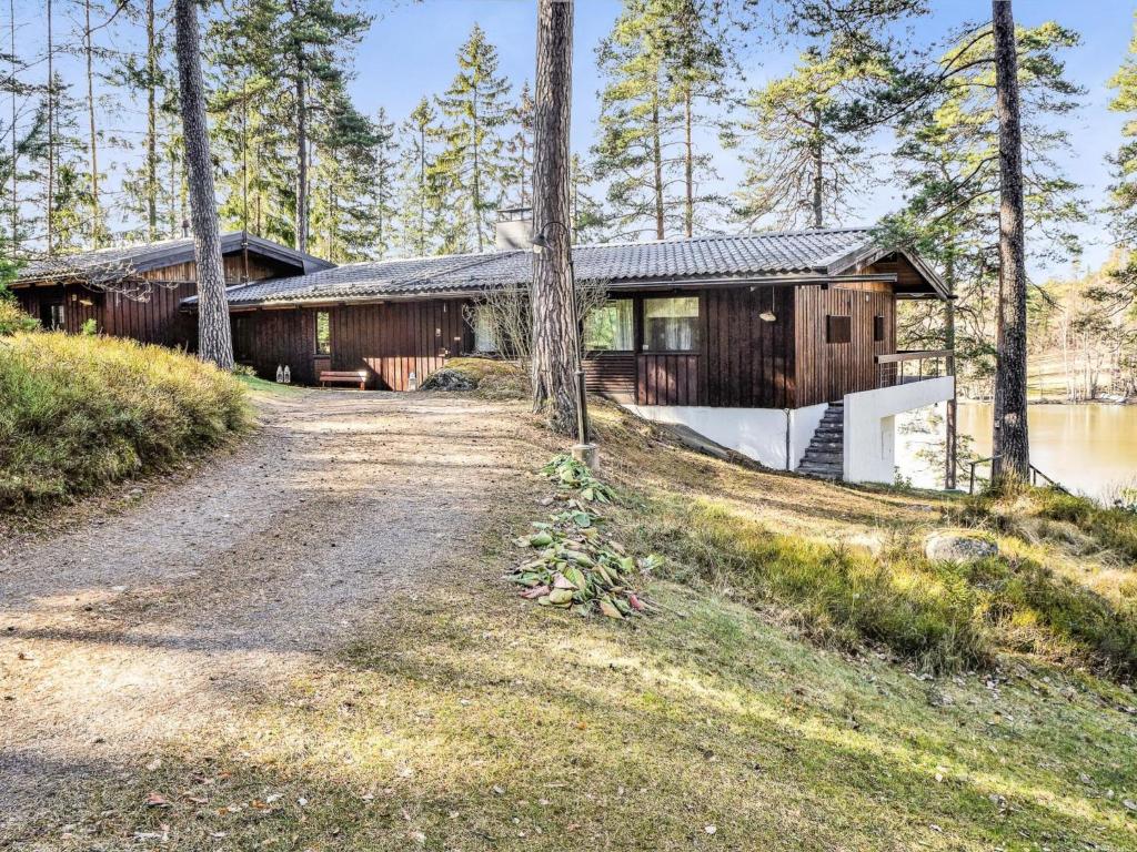 a house in the woods with a dirt road at Holiday Home Pippuriranta by Interhome 