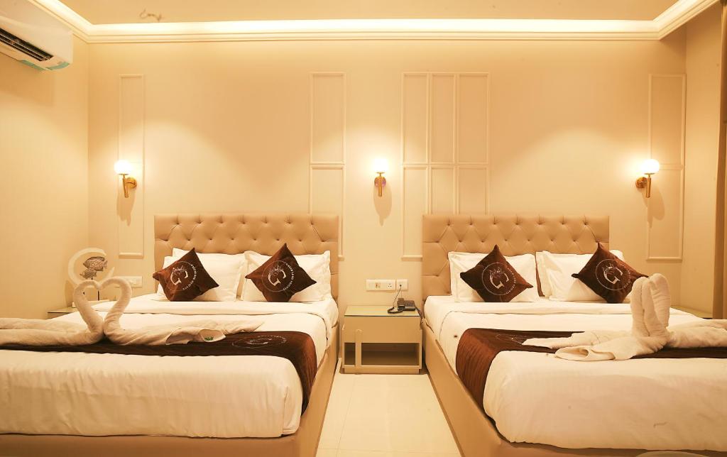 Postel nebo postele na pokoji v ubytování Hotel Green Land Heights