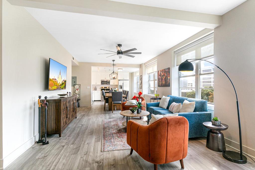 a living room with a blue couch and a table at Lively 4BR Condo Steps to French Quarter in New Orleans
