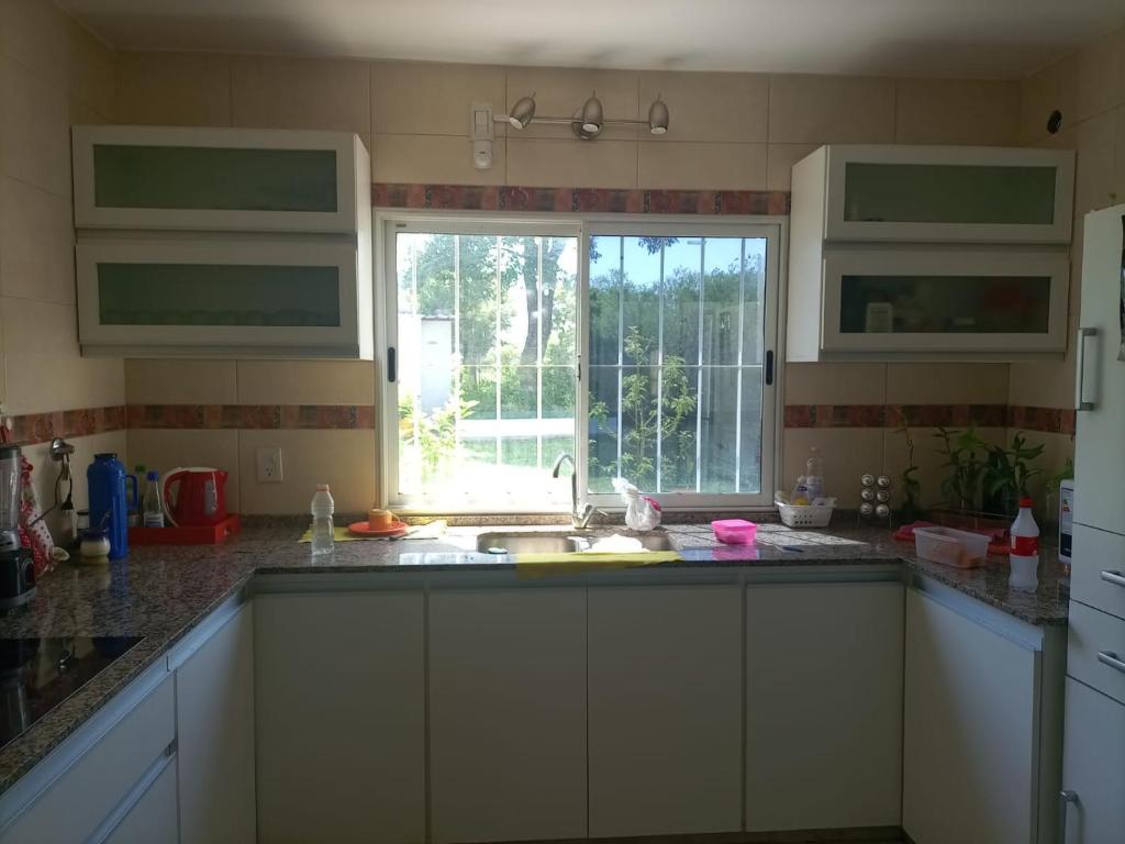 a kitchen with a sink and a window at CASA RUBIA MORENO in La Banda