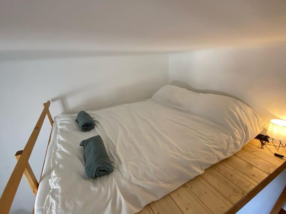 a bed with two pillows on it in a room at Charming apartment in the heart of Gellért area. in Budapest