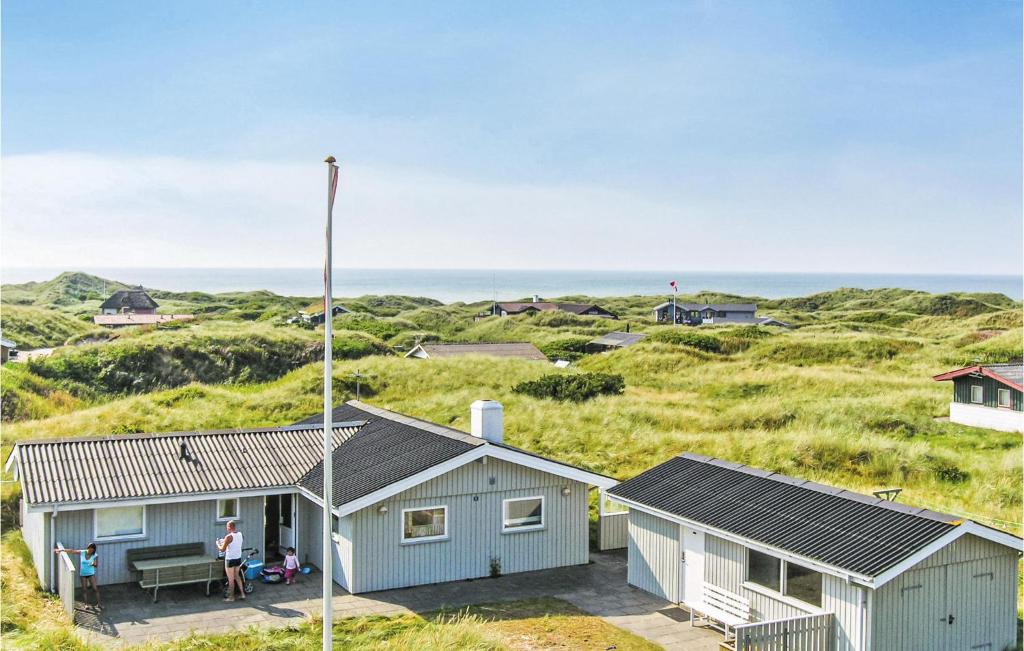 a house on the beach with the ocean in the background at Nice Home In Lkken With 3 Bedrooms And Wifi in Grønhøj