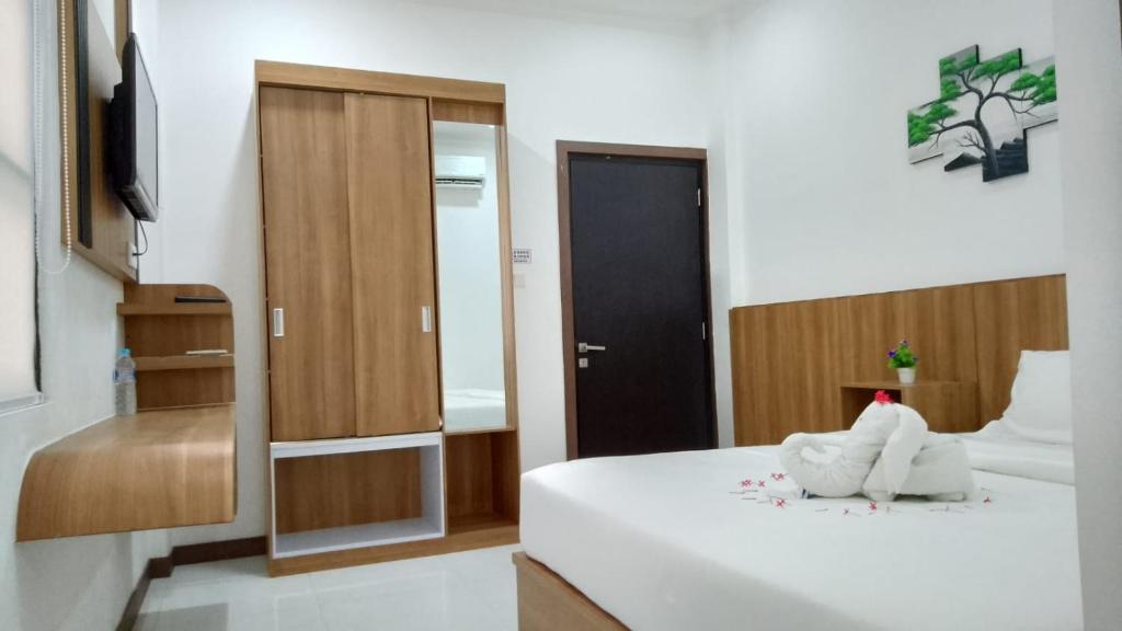 Postel nebo postele na pokoji v ubytování Hotel Bhakti Syariah
