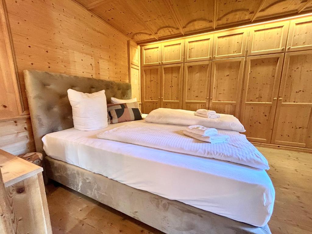 a bedroom with a bed in a wooden room at Ferienhaus Gipfelstürmer in bayerischer Idylle in Bayrischzell