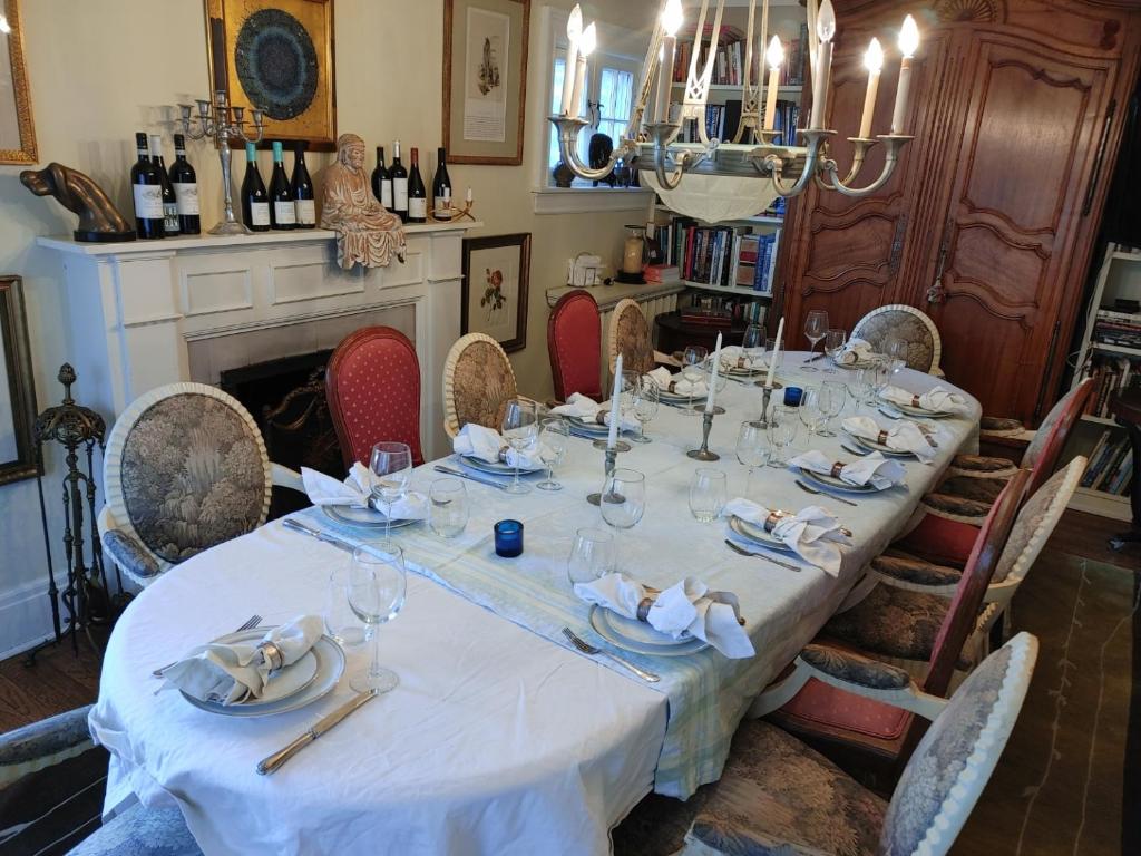 a dining room with a long table with wine glasses at Four Bedroom Rosedale Home in Toronto