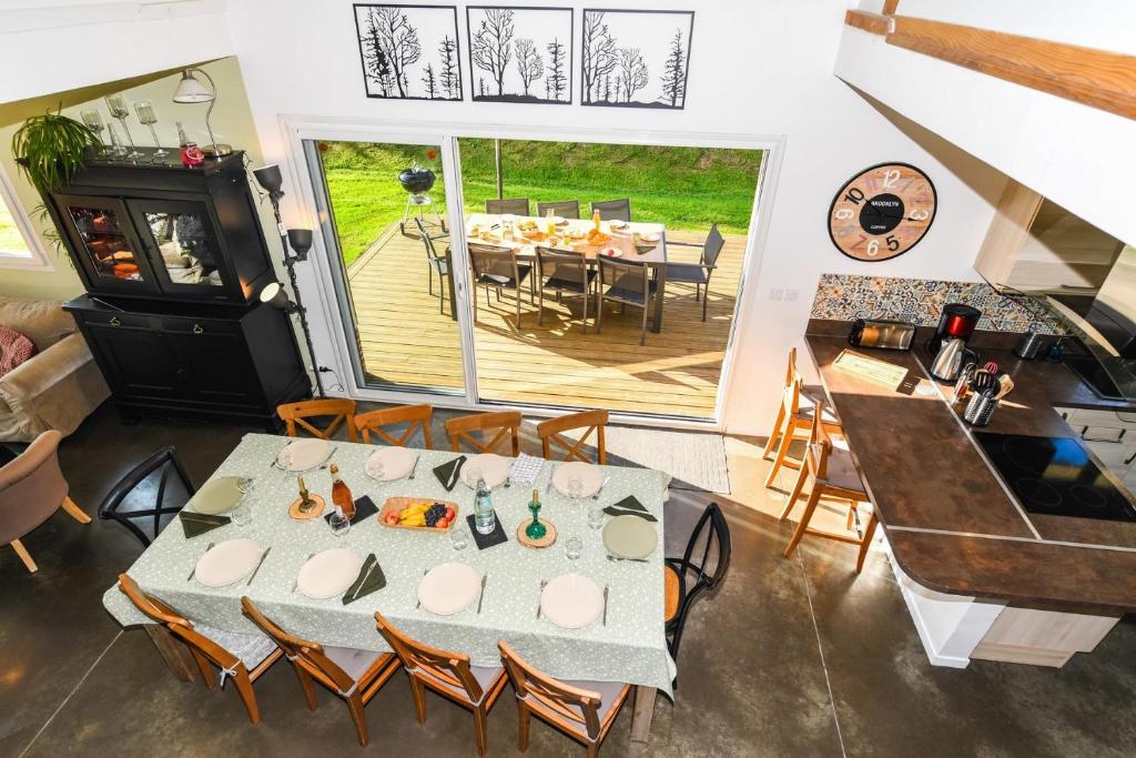 a kitchen and dining room with a table and chairs at Maison Mélèry in Saint-Pierre-du-Val