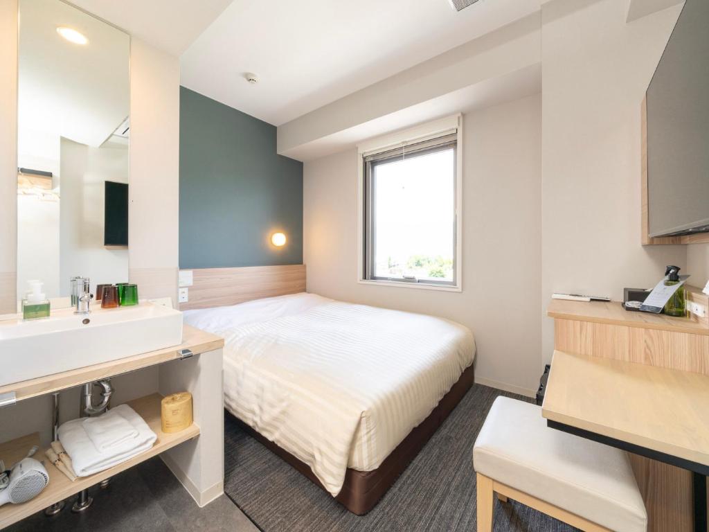 Postel nebo postele na pokoji v ubytování Super Hotel Fujikawaguchiko Tennenonsen
