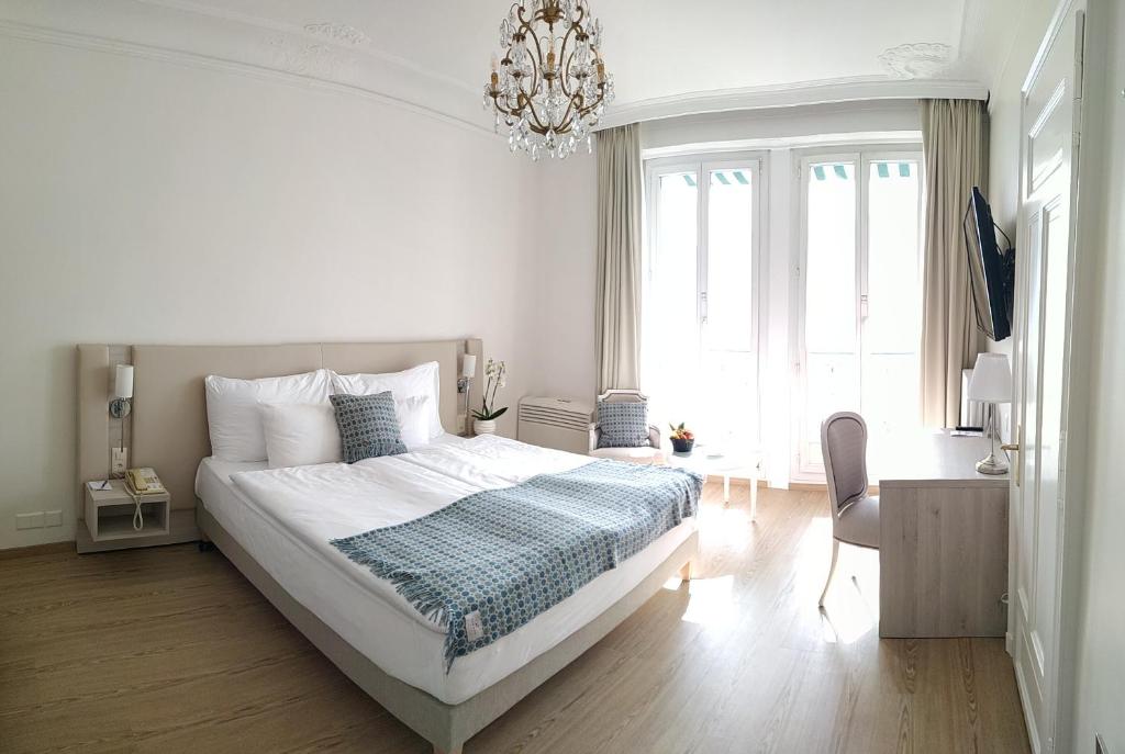 Postel nebo postele na pokoji v ubytování Hotel Eden Palace au Lac
