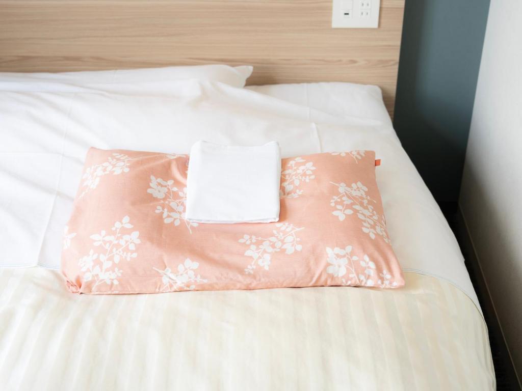 Postel nebo postele na pokoji v ubytování Super Hotel Fujikawaguchiko Tennenonsen