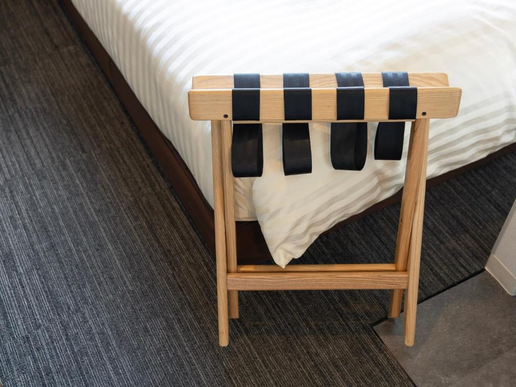 Postel nebo postele na pokoji v ubytování Super Hotel Fujikawaguchiko Tennenonsen