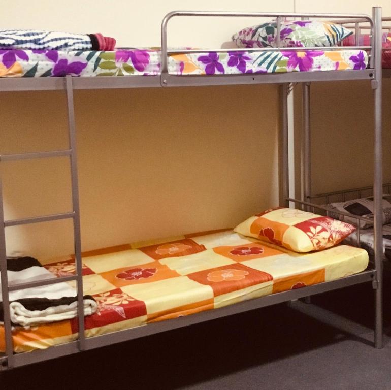 two bunk beds in a room with a mattress at Dubai NorthStar Hostels in Dubai