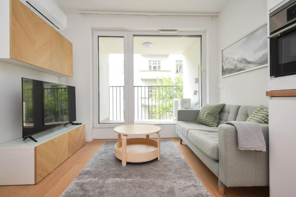 a living room with a couch and a tv at Luxury apartment in city center in Bratislava