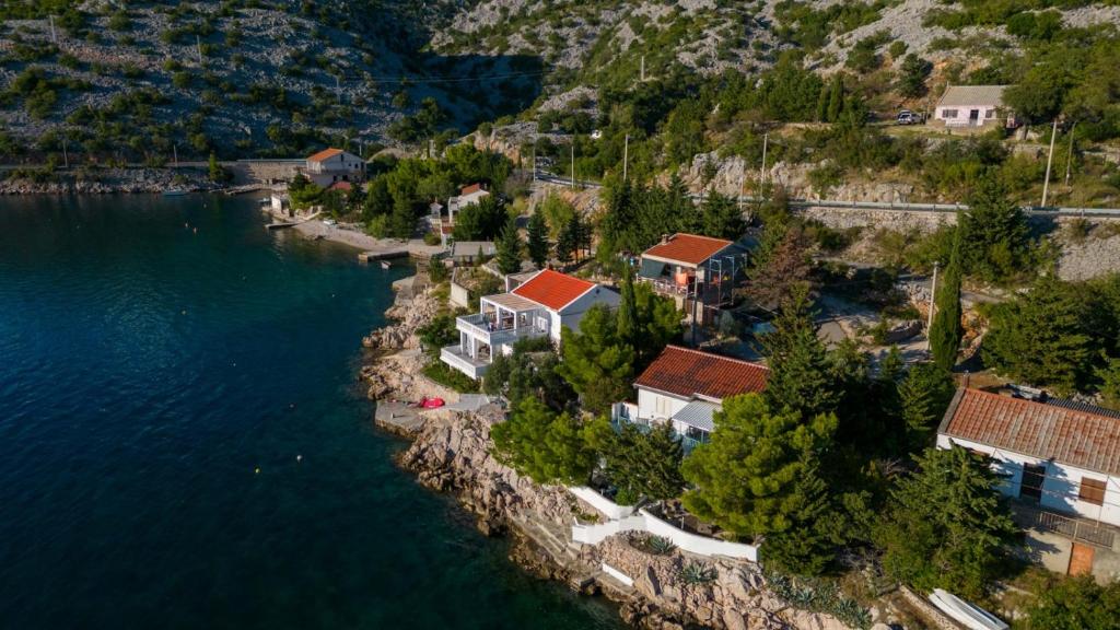 an aerial view of a house on a hill by the water at Kuća za odmor SeaHouse in Karlobag