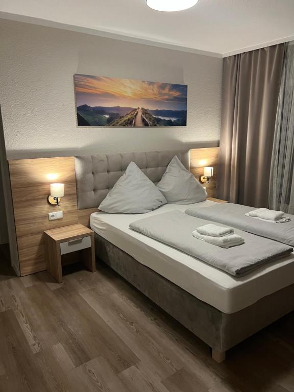 a bedroom with a large bed in a room at Hotel Seewiefken in Wangerland