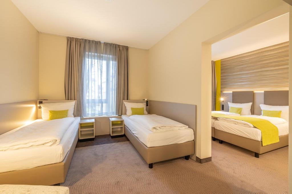 Postel nebo postele na pokoji v ubytování th Hotel Leipzig Messe
