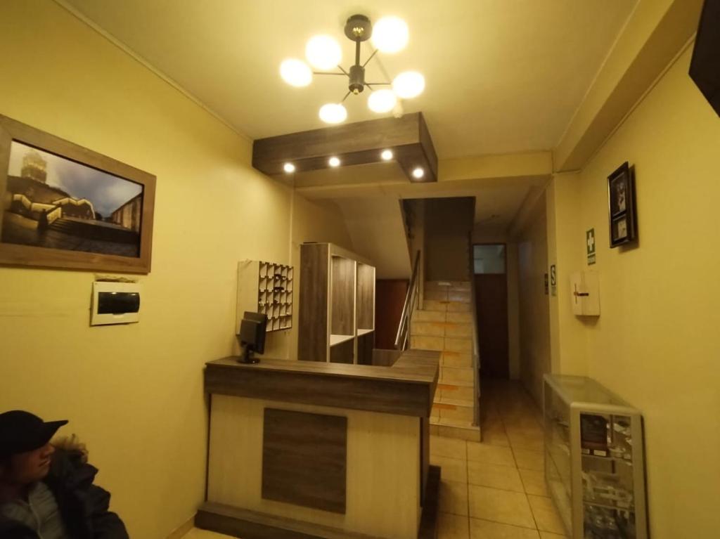 a hallway with a staircase in a building with a room at Hostal Los Andes - Espinar in Espinar
