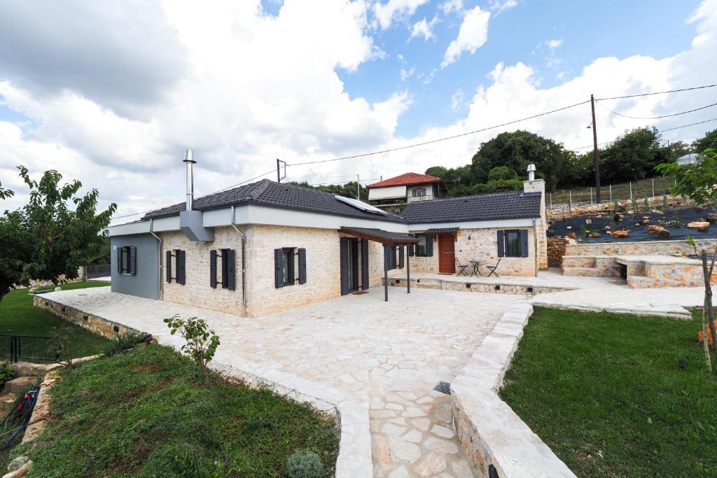 a small house with a large courtyard in front of it at Stonehouse Grace in Ioannina