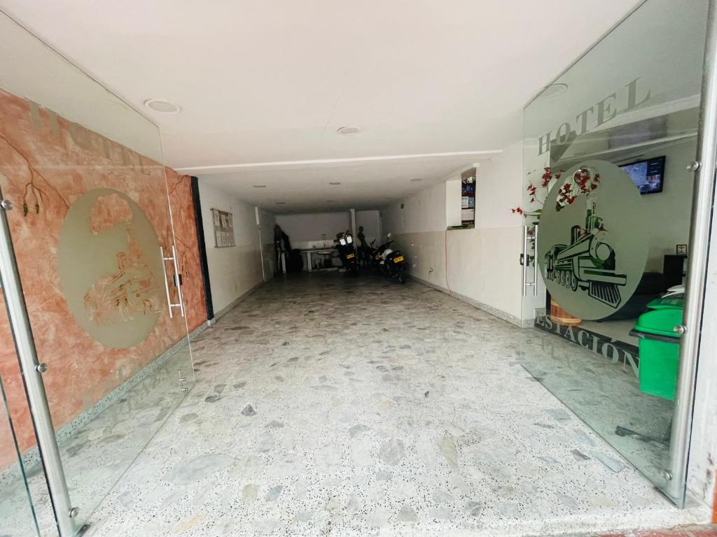 an empty hallway of a building with graffiti on the walls at Estacion plaza in Ibagué