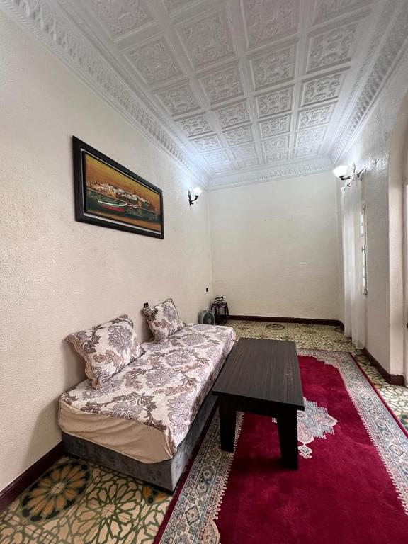 a room with a bed and a table in it at Riad Del Rey in Rabat