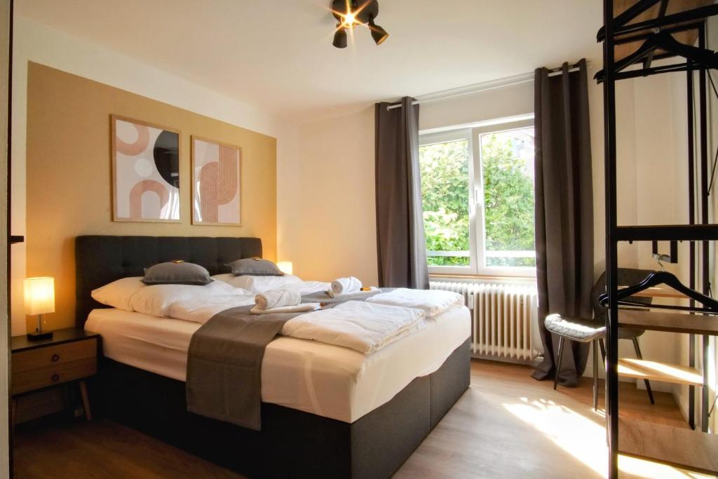 Schlafzimmer mit einem Bett und einem Fenster in der Unterkunft ☆ANDRISS: Kaiserberg Apartments - Kitchen - WIFI - Parking in Kaiserslautern