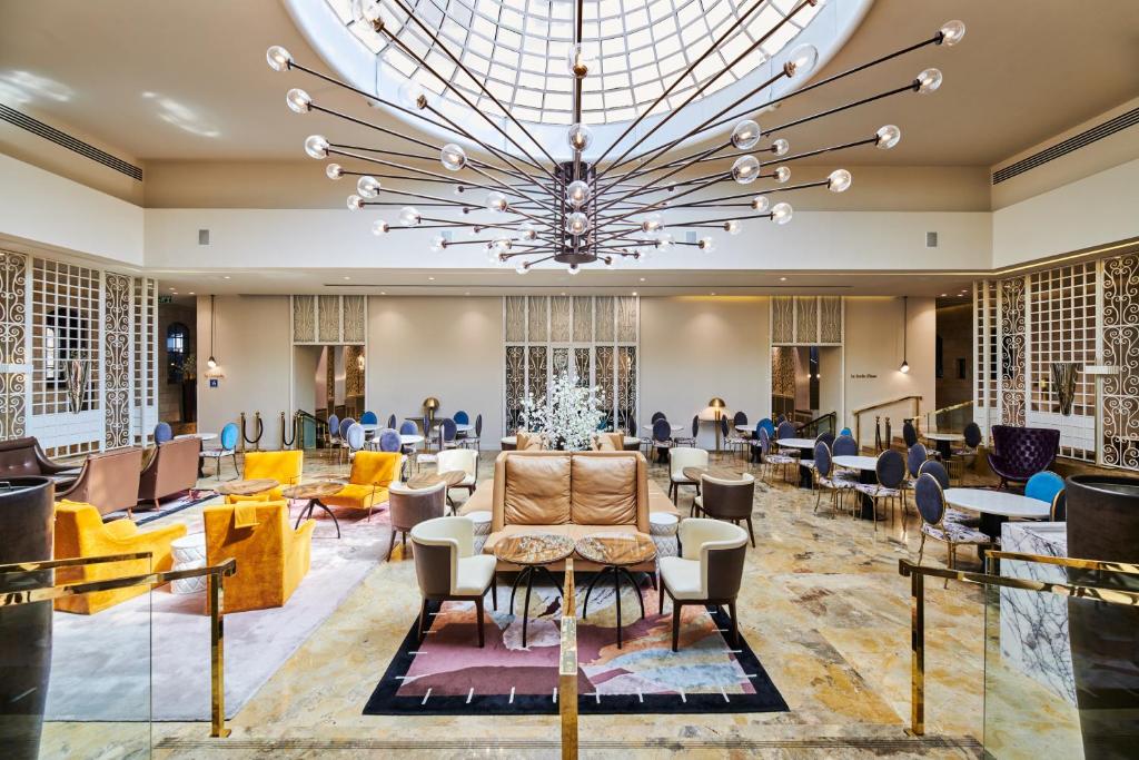 a large lobby with a large chandelier at Lady Stern Jerusalem Hotel in Jerusalem